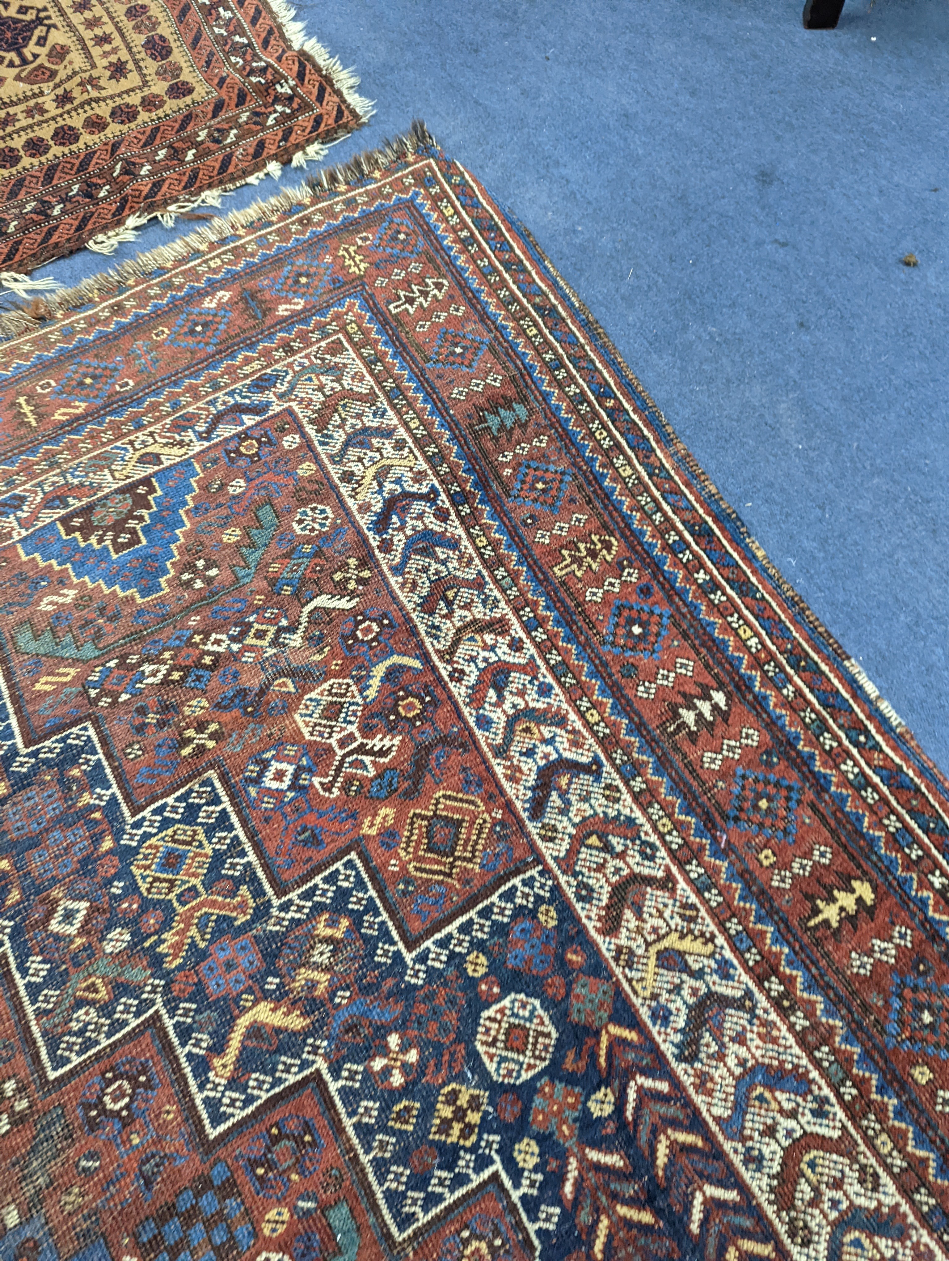 A Caucasian red ground rug and a Belouch rug, larger 200 x 165cm
